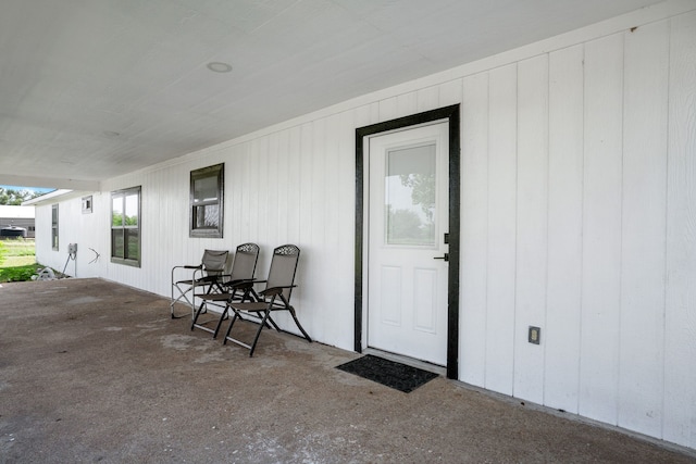 view of exterior entry featuring a patio