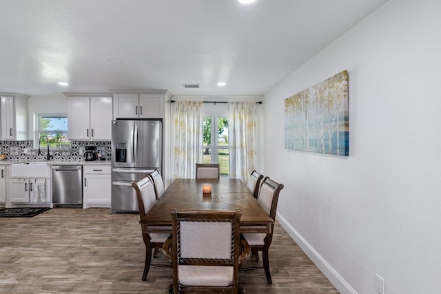 dining area featuring sink and hardwood / wood-style floors