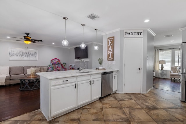 kitchen with sink, appliances with stainless steel finishes, hanging light fixtures, white cabinets, and kitchen peninsula