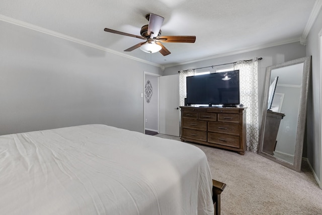 carpeted bedroom featuring ornamental molding and ceiling fan