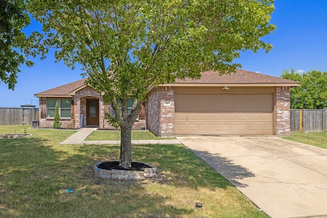 view of front of home featuring a garage and a front lawn