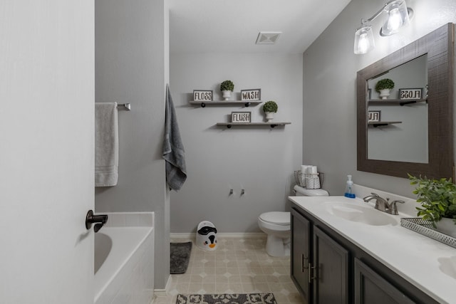 bathroom featuring vanity, toilet, and a bathing tub