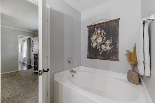 bathroom featuring a bath and ornamental molding