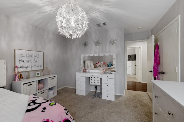 bedroom featuring light carpet and an inviting chandelier