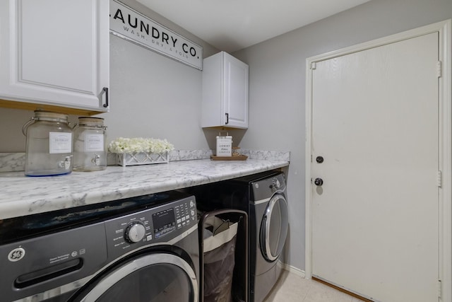 laundry room with separate washer and dryer, light tile patterned floors, and cabinets