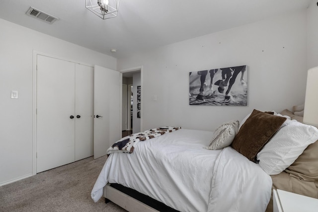 bedroom featuring light colored carpet and a closet