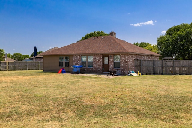 back of house with a lawn