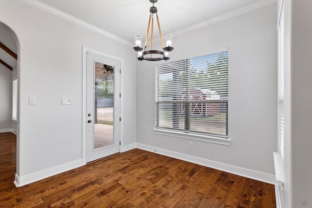 unfurnished dining area featuring a notable chandelier, ornamental molding, and wood-type flooring