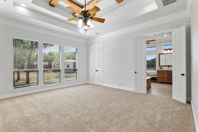 unfurnished room with a tray ceiling, ceiling fan, and light tile patterned floors