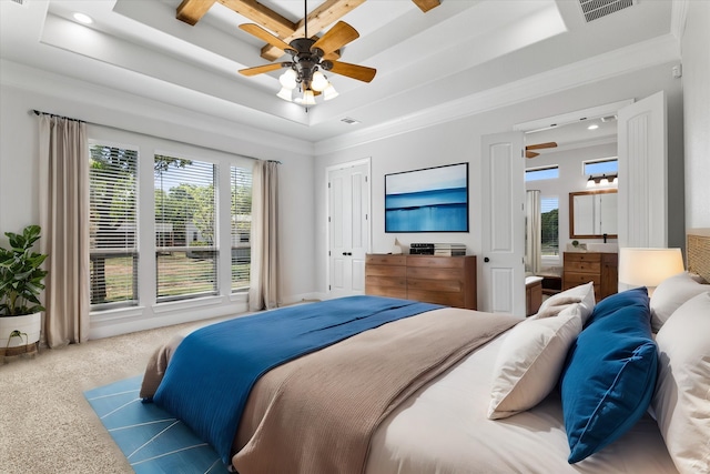 carpeted bedroom featuring a raised ceiling, multiple windows, and ceiling fan