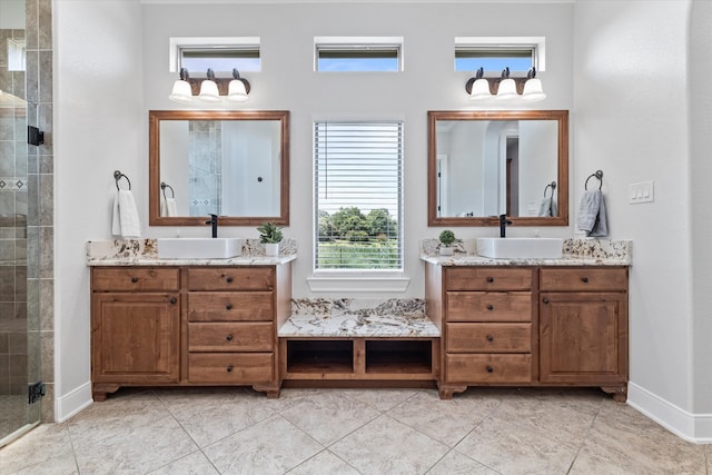 bathroom featuring a shower with shower door, tile patterned flooring, and double vanity