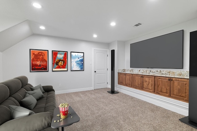 home theater featuring lofted ceiling and light colored carpet