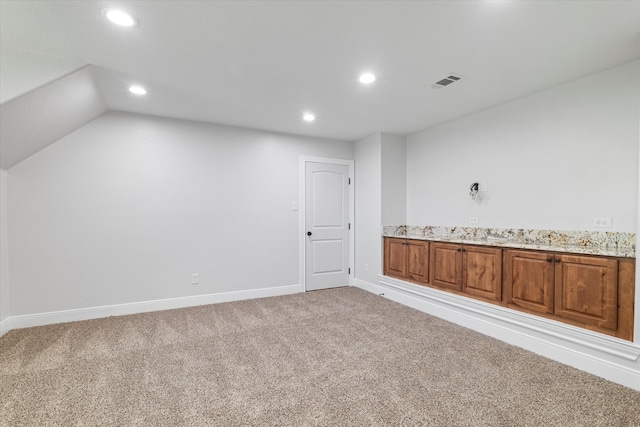 additional living space with lofted ceiling and light colored carpet