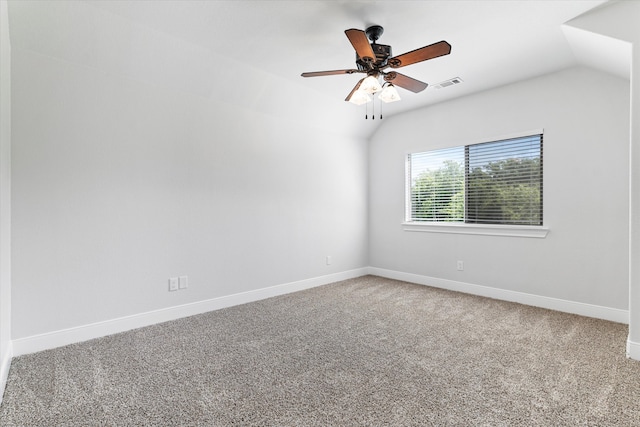 carpeted spare room featuring ceiling fan and vaulted ceiling