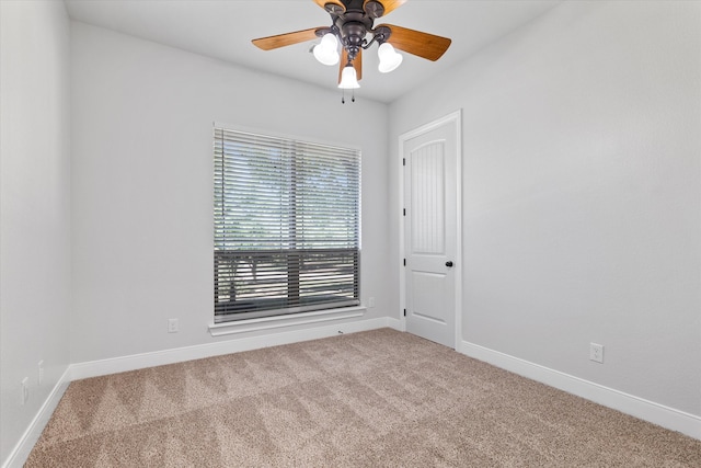 empty room featuring carpet floors and ceiling fan