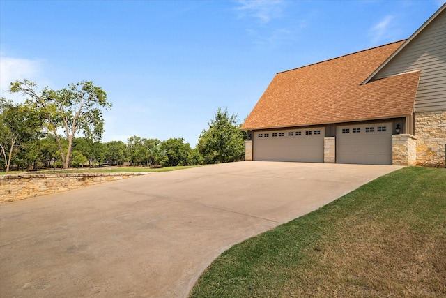 view of home's exterior with a garage and a yard