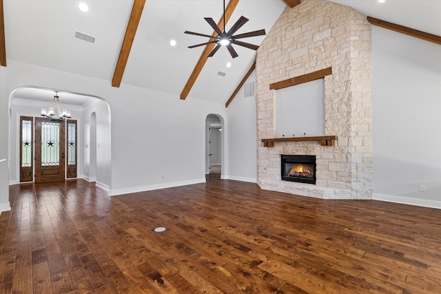 unfurnished living room featuring a stone fireplace, beamed ceiling, hardwood / wood-style floors, and high vaulted ceiling