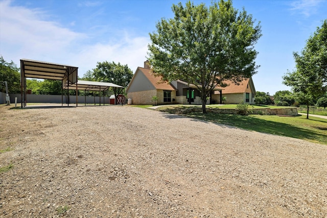 view of front of home with a front lawn and a carport