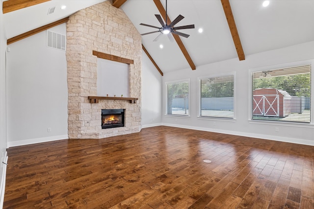 unfurnished living room with hardwood / wood-style floors, a fireplace, beam ceiling, high vaulted ceiling, and ceiling fan