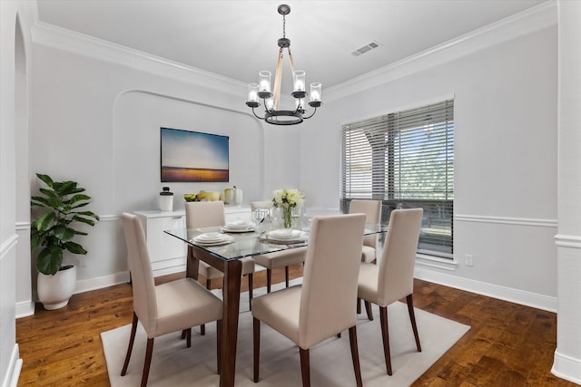 dining space with a notable chandelier, dark hardwood / wood-style flooring, and crown molding