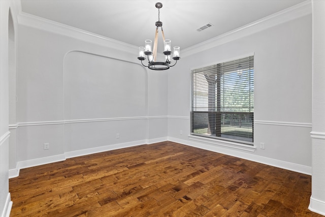 spare room with hardwood / wood-style flooring, crown molding, and a chandelier