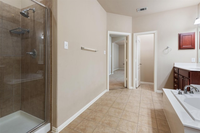 bathroom featuring tile patterned flooring, vanity, and shower with separate bathtub