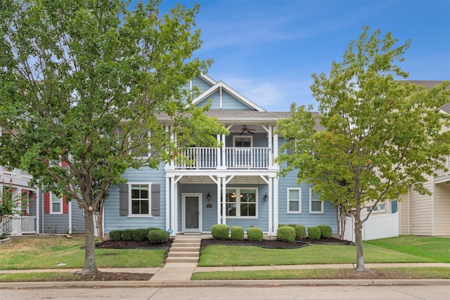 view of front of house featuring a balcony and a front lawn