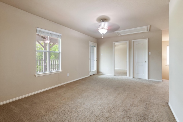 carpeted empty room featuring ceiling fan