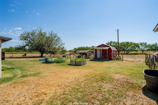 view of yard with a storage unit and a rural view