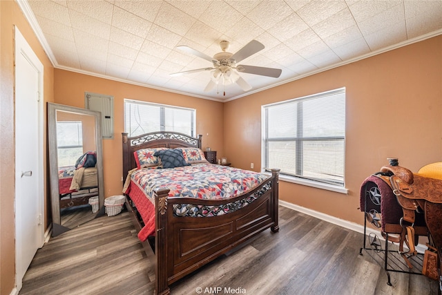 bedroom featuring ornamental molding, dark wood-type flooring, and ceiling fan