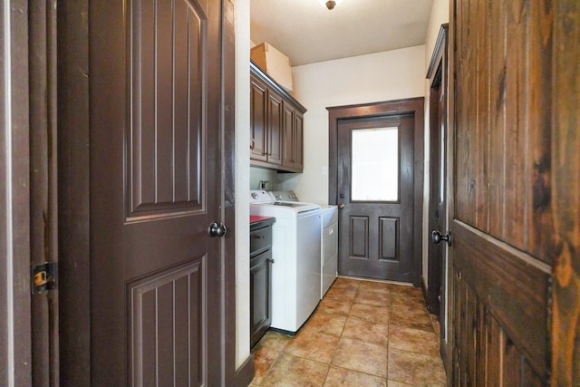 clothes washing area featuring light tile patterned floors, cabinet space, and independent washer and dryer