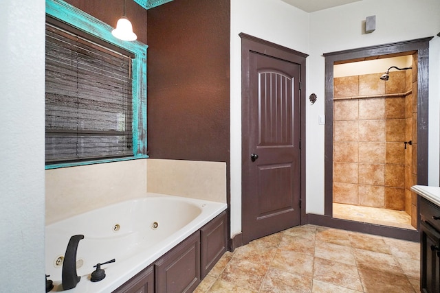 bathroom featuring shower with separate bathtub and vanity