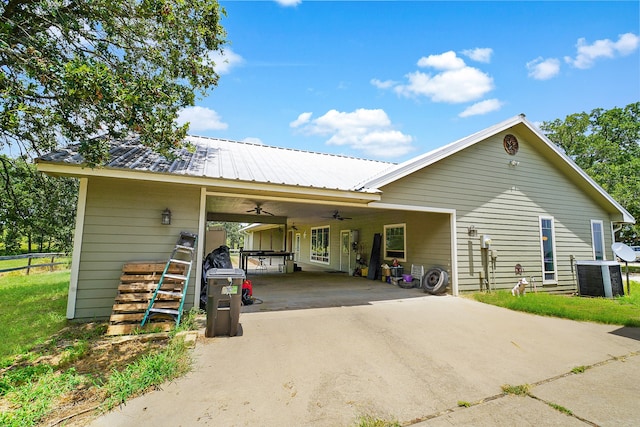 garage featuring ceiling fan, a carport, and central air condition unit