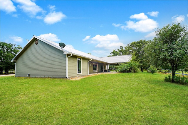 back of property featuring a lawn