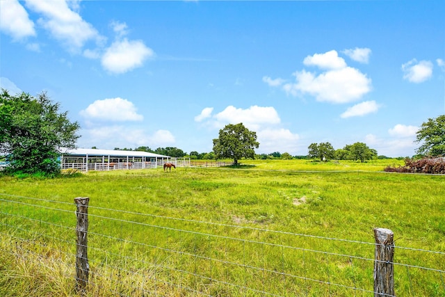 view of yard with an exterior structure, an outbuilding, and a rural view