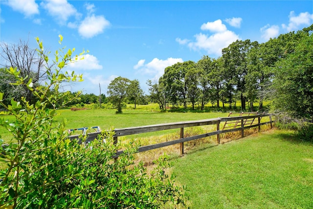 view of yard featuring a rural view and fence