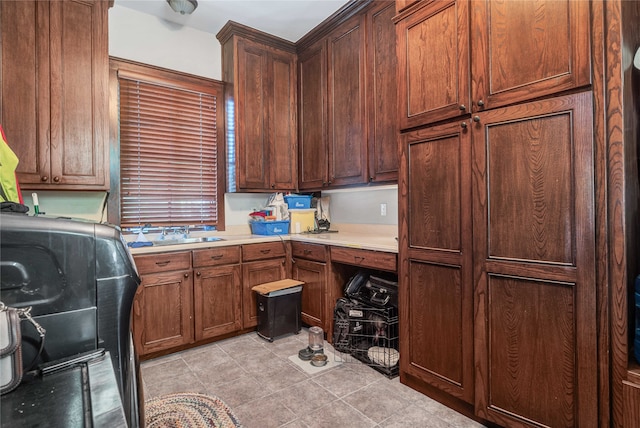 kitchen with sink and light tile patterned flooring