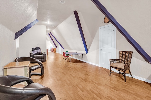 living area with lofted ceiling and light wood-type flooring