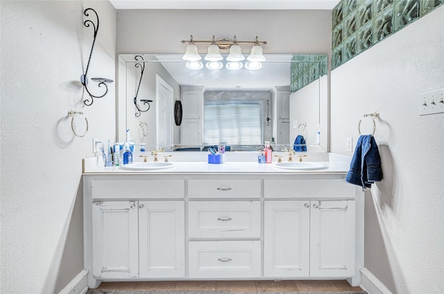 bathroom featuring tile patterned floors and dual bowl vanity