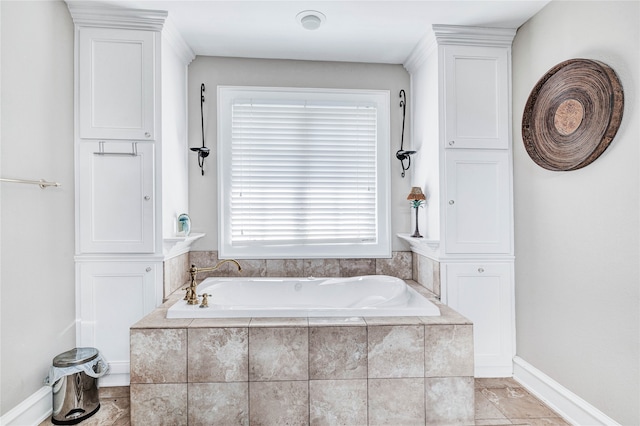 bathroom with a relaxing tiled tub and tile patterned floors