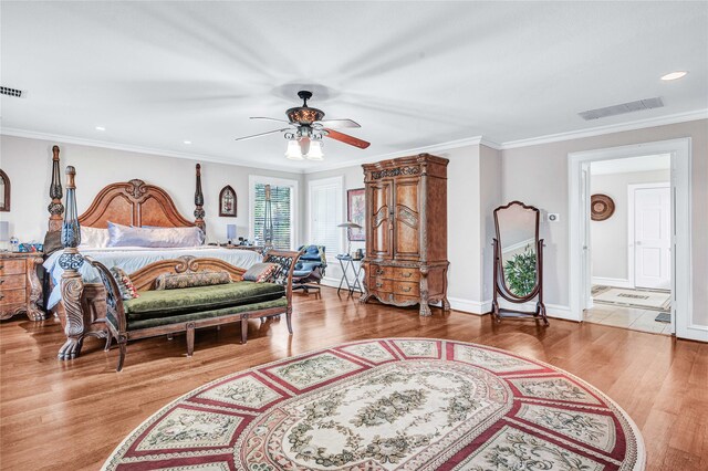 bedroom with crown molding, ceiling fan, and hardwood / wood-style floors