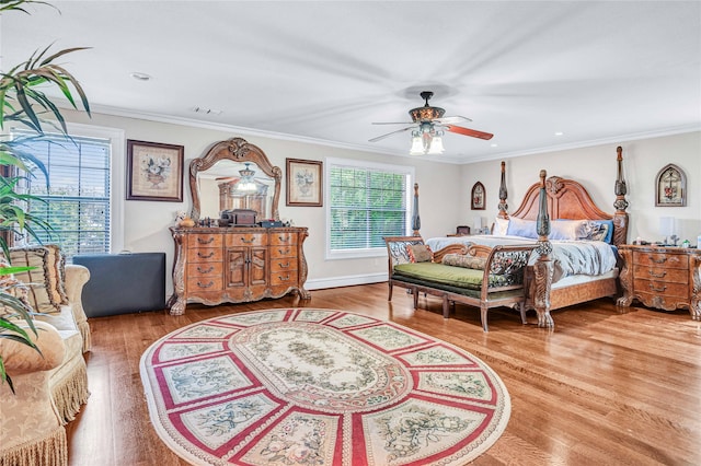 bedroom featuring ornamental molding, hardwood / wood-style floors, and ceiling fan