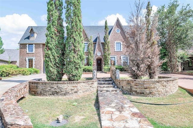 tudor house with a front lawn