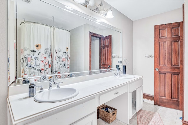 bathroom with dual vanity and tile patterned floors