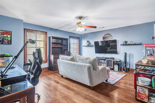 living room with hardwood / wood-style flooring and ceiling fan