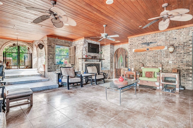 interior space with brick wall, wooden ceiling, and ceiling fan