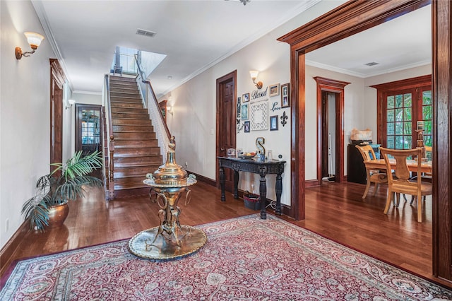 entryway with french doors, crown molding, and hardwood / wood-style floors