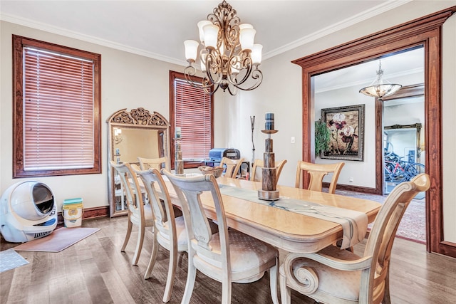 dining room featuring a chandelier, hardwood / wood-style flooring, and crown molding