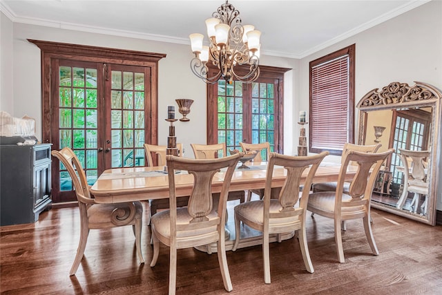 dining space featuring hardwood / wood-style flooring, a chandelier, french doors, and crown molding