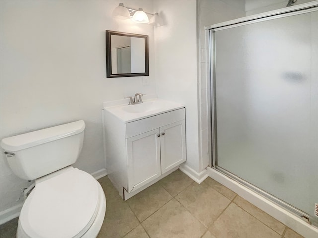 bathroom with a shower with shower door, vanity, tile patterned floors, and toilet